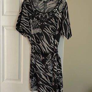 Black and silver dress. Knee length. Jeweled neckline. Tie belt.